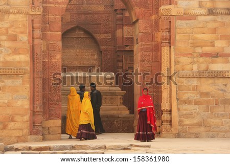 DELHI, INDIA - JANUARY 27: An unidentified woman stands at Qutub Minar complex on January 27, 2011 in Delhi, India. Qutub Minar is the tallest minar in India, originally an ancient Islamic Monument.