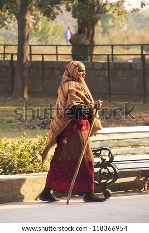 DELHI, INDIA - JANUARY 24: An unidentified woman walks in the street on January 24, 2011 in Delhi, India. Delhi is the world\'s second most populous city and the largest city in India.