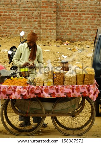 DELHI, INDIA - JANUARY 27: An unidentified man sells food on the street on January 27, 2011 in Delhi, India. Delhi is the world\'s second most populous city and the largest city in India.