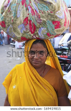 BUNDI, INDIA - FEBRUARY 4: An unidentified woman walks in the street on February 4, 2011 in Bundi, India. Bundi is a popular place of attraction and tourism industry primarily supports its economy.