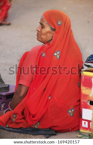 BUNDI, INDIA - FEBRUARY 4: An unidentified woman sits in the street on February 4, 2011 in Bundi, India. Bundi is a popular place of attraction and tourism industry primarily supports its economy.