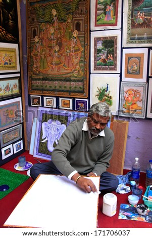 UDAIPUR, INDIA - FEBRUARY 8: Unidentified man paints in his studio on February 8, 2011 in Udaipur, India. Udaipur is particularly famous for its miniature paintings in style of Rajputs and Mughals.