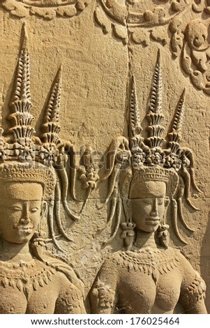 SIEM REAP, CAMBODIA - DECEMBER 21: Wall bas-relief of Devatas in Angkor Wat temple on December 21, 2011 in Siem Reap, Cambodia. Angkor Wat is the world\'s largest single religious monument.