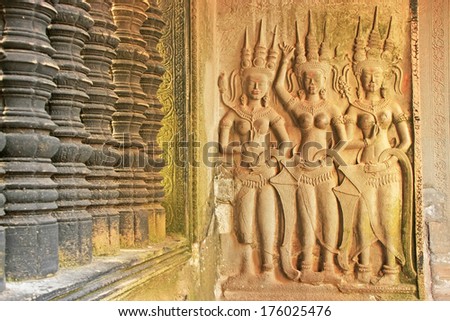 SIEM REAP, CAMBODIA - DECEMBER 21: Wall bas-relief of Devatas in Angkor Wat temple on December 21, 2011 in Siem Reap, Cambodia. Angkor Wat is the world\'s largest single religious monument.