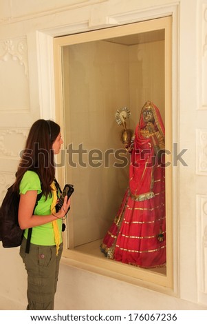 JODHPUR, INDIA-FEBRUARY 11: An unidentified woman looks at display of traditional dress in Mehrangarh Fort on February 11, 2011 in Jodhpur, India. Mehrangarh Fort is one of the largest forts in India.