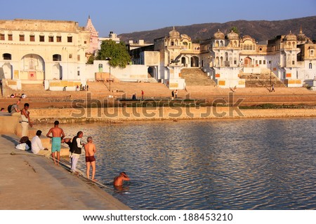 PUSHKAR, INDIA - FEBRUARY 23: Unidentified men bath in holy lake on February 23, 2011 in Pushkar, India. Pushkar is one of the five sacred pilgrimage sites for devout Hindus.