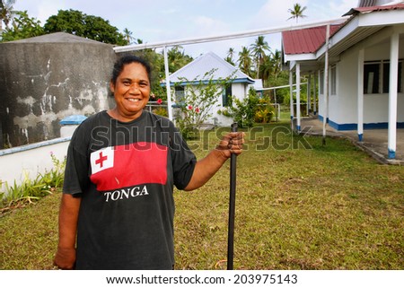OFU ISLAND, TONGA - NOVEMBER 15: An unidentified woman cleans church yard on Ofu island on November 15, 2013 in Tonga. Tonga is a Polynesian sovereign state and archipelago comprising 176 islands.