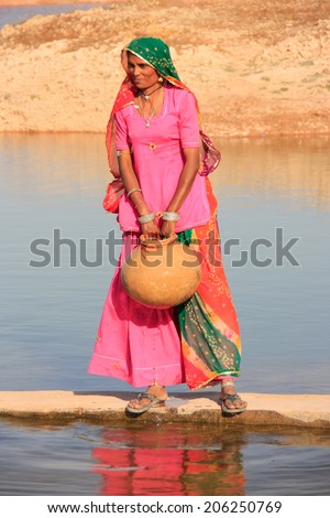 KHICHAN, INDIA - FEBRUARY 12: An unidentified woman gets water from reservoir on February 12, 2011 in Khichan, India.