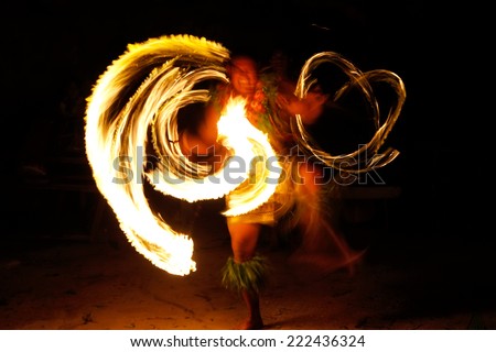 TONGATAPU, TONGA - NOVEMBER 13: Unidentified man performs fire dance (blurred motion) in Hina cave on November 13, 2013 in Tongtapu, Tonga. Famous Hina cave is a big tourist attraction on Tongatapu.