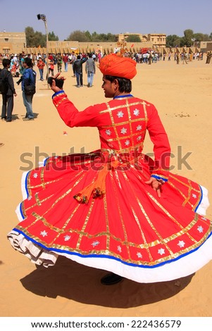JAISALMER, INDIA - FEBRUARY 16: Unidentified man dances during Desert Festival on February 16, 2011 in Jaisalmer, India. Main purpose of Festival is to display rich and colorful culture of  Rajasthan
