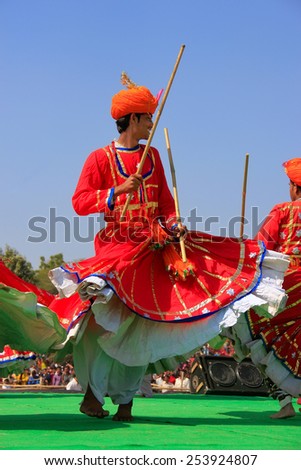 JAISALMER, INDIA - FEBRUARY 16: Unidentified men dance during Desert Festival on February 16, 2011 in Jaisalmer, India. Main purpose of Festival is to display rich and colorful culture of Rajasthan