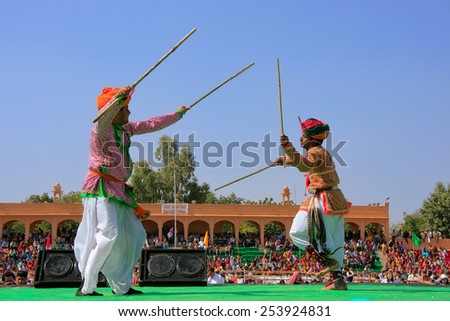 JAISALMER, INDIA - FEBRUARY 16: Unidentified men dance during Desert Festival on February 16, 2011 in Jaisalmer, India. Main purpose of Festival is to display rich and colorful culture of Rajasthan