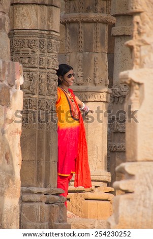 DELHI, INDIA - NOVEMBER 4: Unidentified woman stands in Quwwat-Ul-Islam mosque courtyard at Qutub Minar complex on November 4, 2014 in Delhi, India. Qutub Minar is the tallest minar in India.