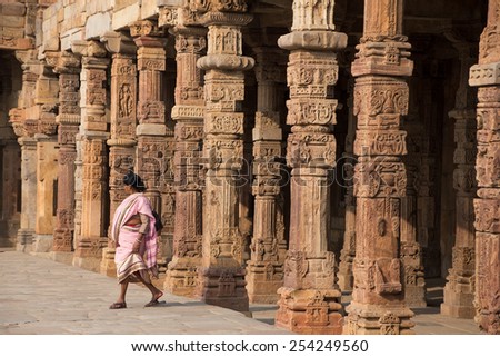 DELHI, INDIA - NOVEMBER 4: Unidentified woman walks in Quwwat-Ul-Islam mosque courtyard at Qutub Minar complex on November 4, 2014 in Delhi, India. Qutub Minar is the tallest minar in India