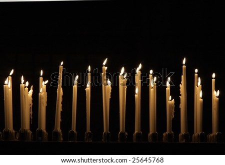 Burning candles in cathedral Duomo in Milan