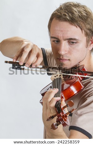 A guy playing a violin.