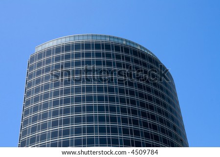 Oval contemporary office building or hotel against a blue sky