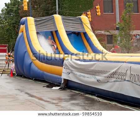 GRAND RAPIDS, MI- AUG 21: Lyon Street is transformed into a waterpark with a 500-foot water slide, said to be the world\'s longest, installed by Rob Bliss Events on Aug 21, 2010 in Grand Rapids, MI.