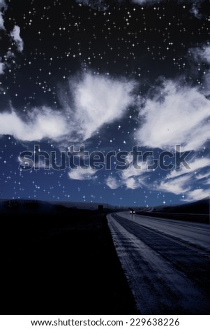 Single car travels on dark road under stars