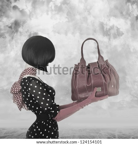 Art photo elegant lady with stylish short hairstyle holding a bag
