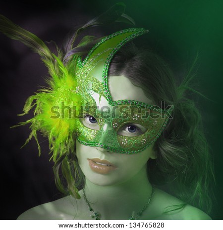 Close up portrait of woman in green mask