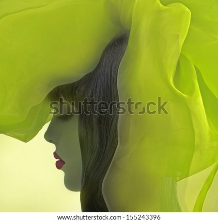 Profile Of Beautiful Girl With Fantasy Green Drapery.
