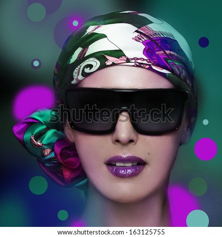 Beautiful woman in big violet fashion sunglasses and shawl.