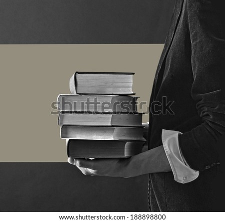 Reading and student college concept. Man holding a pile of old books for studying.