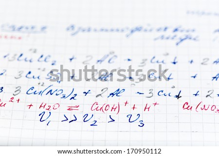 Handwriting test paper on chemistry with teacher`s corrections as background