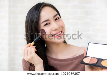 Young beautiful Asian woman professional beauty vlogger or blogger  doing a make up tutorial