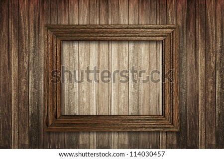 Wooden picture frame on wooden wall