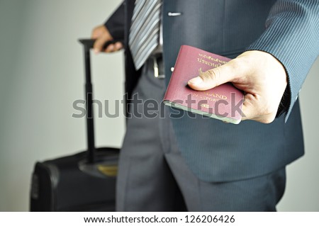 Traveling Businessman Handing Passport - Airport Security Concept