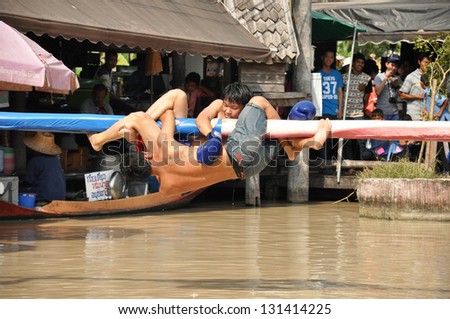PATTAYA, THAILAND - MAR. 2 :traditional water Thai boxing (or Muay Talay) - ancient Thai fight above the water - at Pattaya floating market, Thailand  on Mar 2, 2013.
