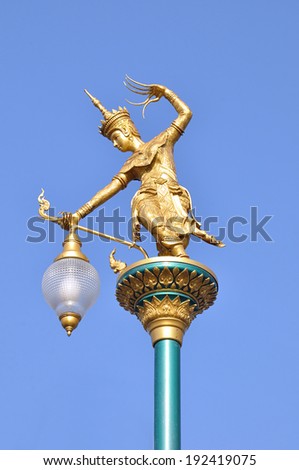 Ancient Thai style street lamp - golden woman statue as legendary character performing ancient Thai dance