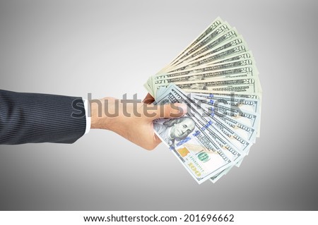 Money - hand holding banknotes - United States Dollars or USD