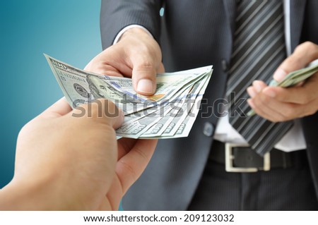 Hand receiving money from businessman - United States dollar (USD) bills