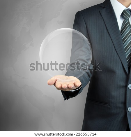 Businessman hand carrying empty transparent ball or globe - can put your objects or texts inside