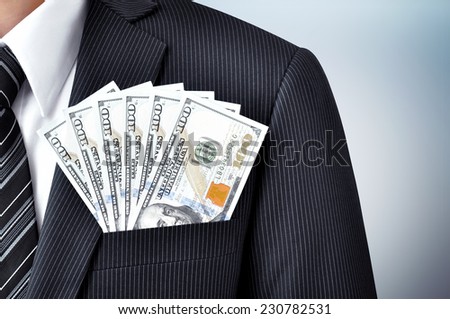 Money - United States dollar (or USD) banknotes in businessman suit pocket