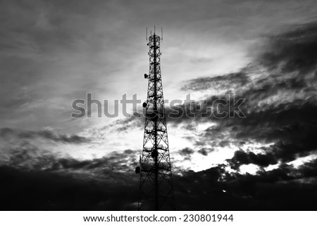 Telecom tower on sky & clouds background - monochrome effect