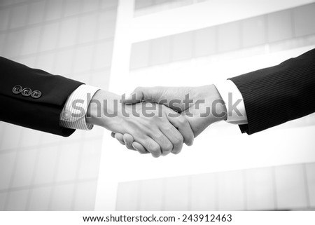 Handshake of businessmen, greeting, dealing, partnership, merger & acquisition concepts - monochrome effect