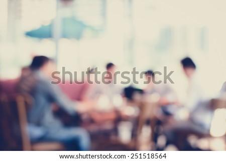 People sitting in coffee shop, blurred background - vintage & retro style color effect