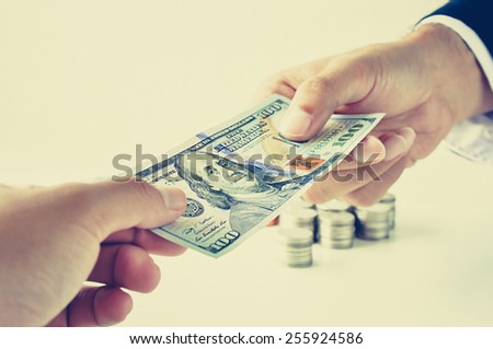 Hands giving & receiving money, 100 US dollars (USD) bill - vintage (retro) style color effect
