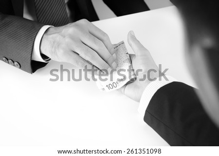 Businessman hands giving & receiving money, Euro currency (EUR), bribery concept - monochrome effect