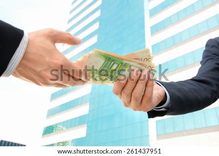 Businessman hands giving & receiving money - Euro currency (EUR)