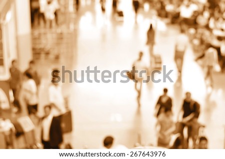 Blurred people at the airport hallway in brown sepia effect, can be used as background