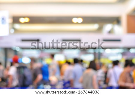 Blurred image of crowd at the hallway of airport terminal - can be used as background