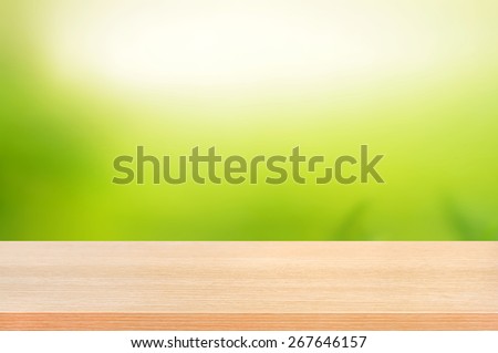 Wood table top on abstract nature green background - can use  for display or montage you products