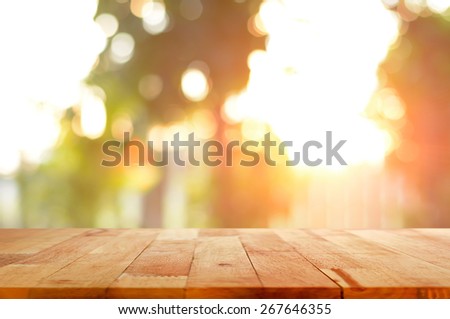 Wood table top on shiny sunlight bokeh background - can used for display or montage your products