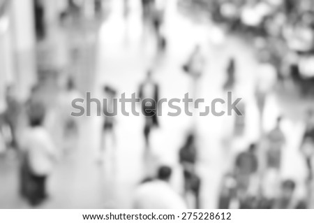 Blurred people at the airport hallway in monochrome effect, can be used as background