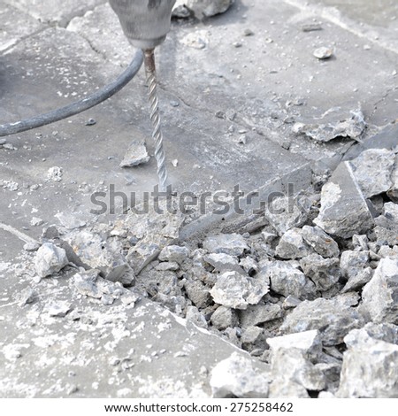 Drilling machine breaking concrete floor